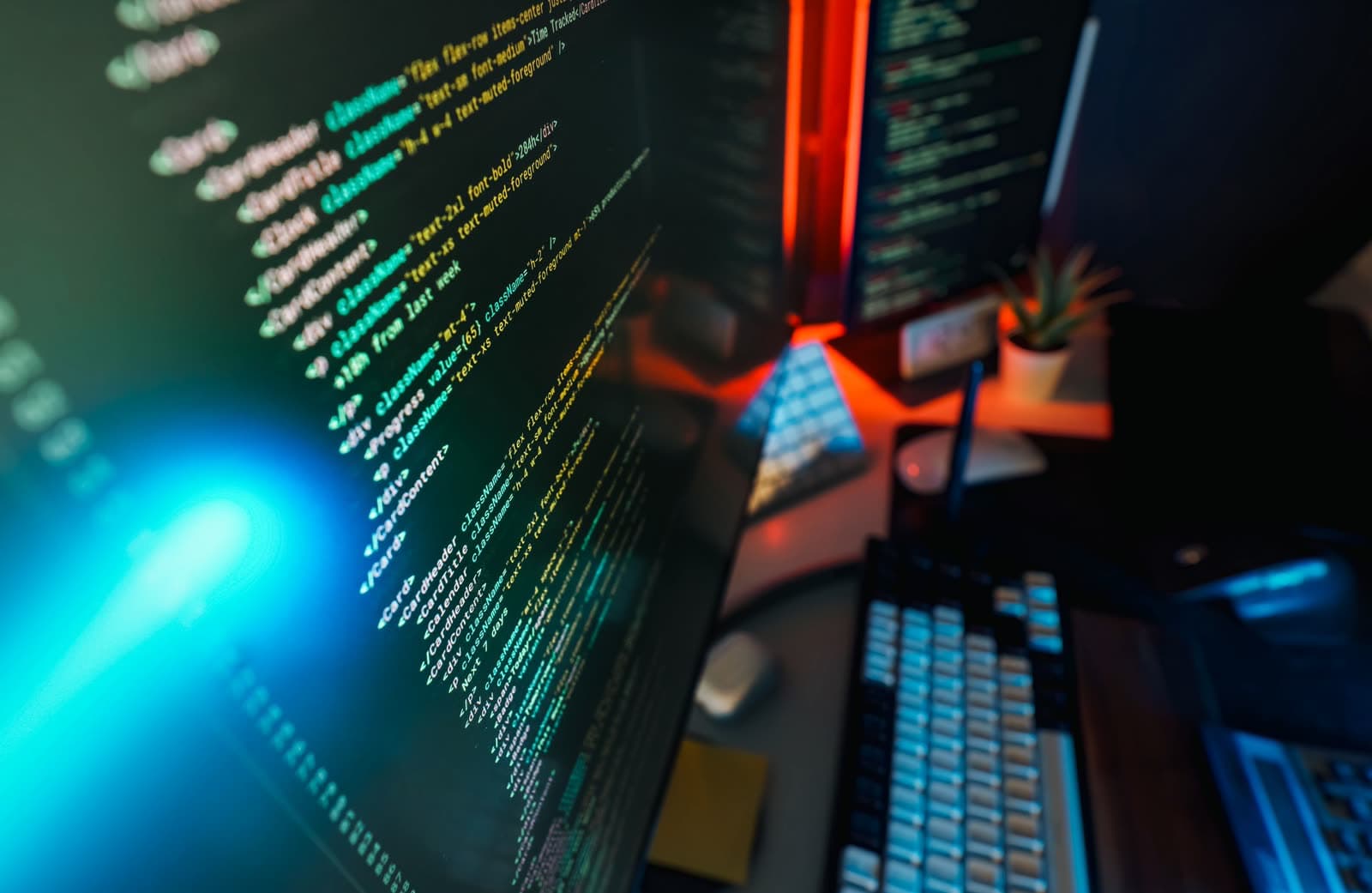 Developer workstation with code on multiple monitors, illustrating PHP website security