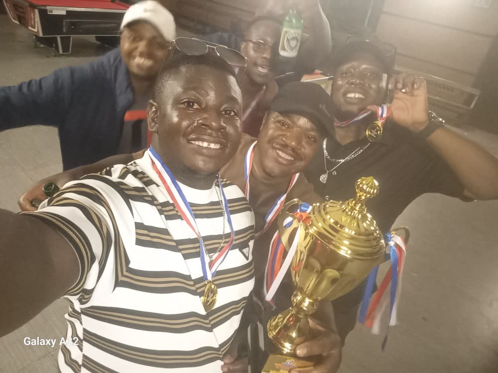 Tyflex team members smiling together with the winning trophy after the pool final